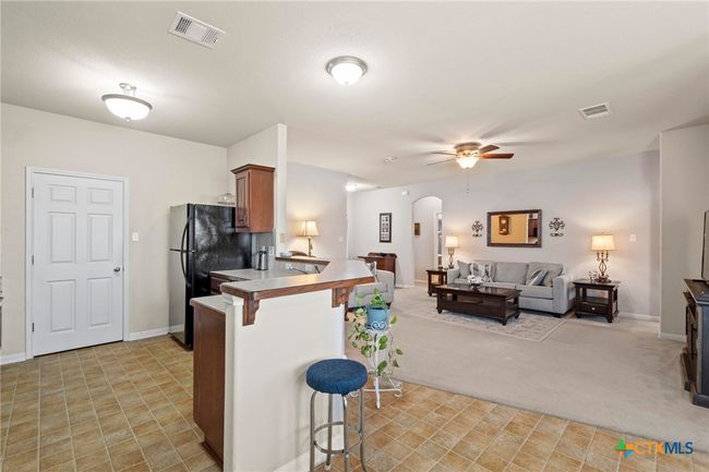 kitchen with breakfast bar open to living | Image 9