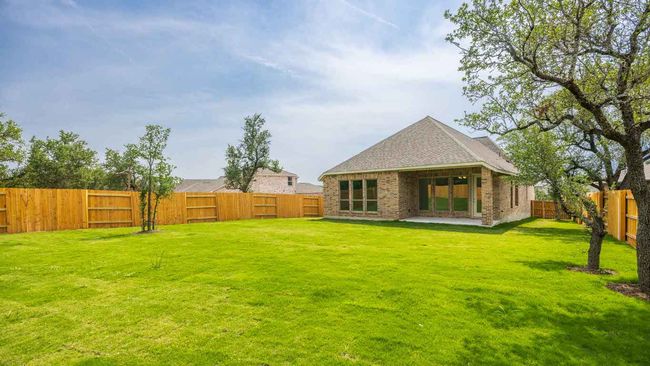 Back of house featuring roof with shingles and a patio area | Image 11