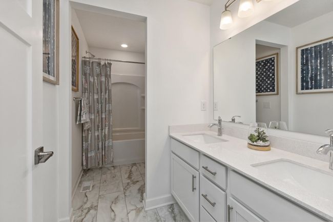 Photo is of the actual model. Featuring a double-vanity, this secondary bath is sure to keep everyone moving during those busy mornings. | Image 22