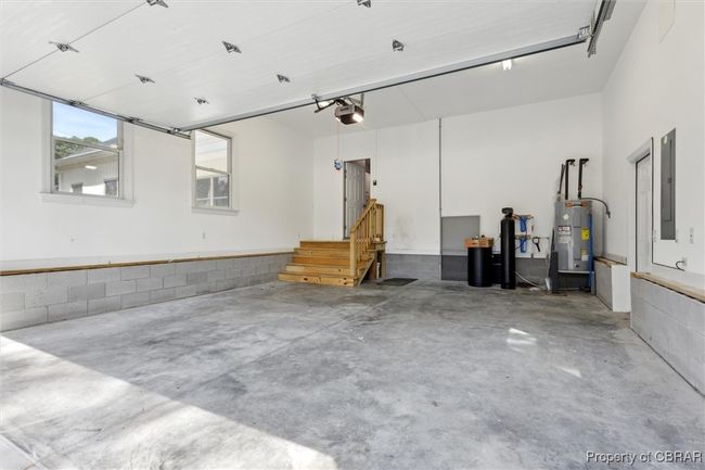 Garage with water heater, a garage door opener, and electric panel | Image 28