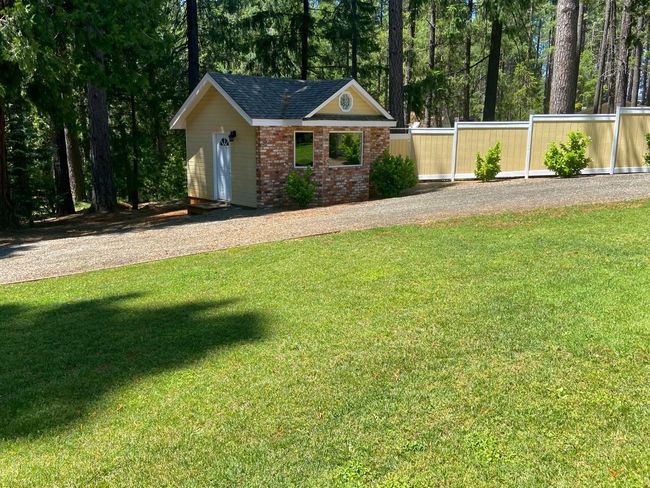 Cottage studio with brick front to match the home is currently a work out room. Would make a great office or overflow guest room? | Image 38