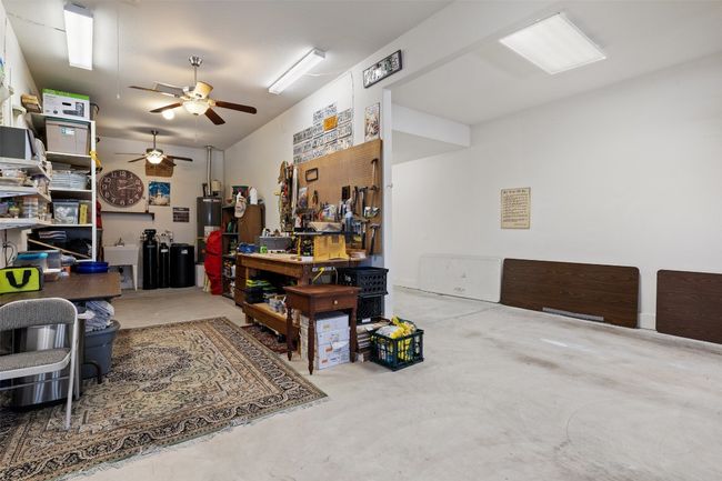 Enjoy working in your rare 5-car garage, equipped with two ceiling fans and vented garage doors to help regulate temperature — perfect for projects, hobbies, or your dream workshop! | Image 38