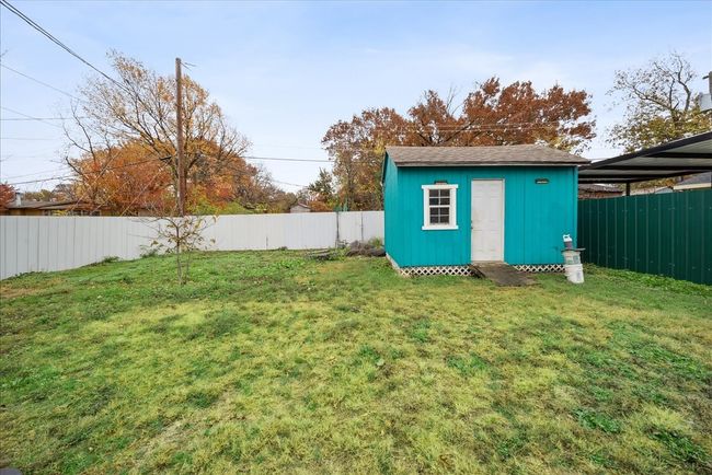 Fenced backyard with a shed | Image 22