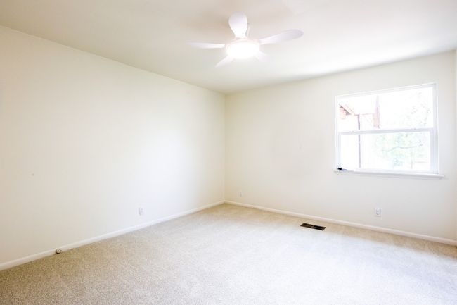 Spare room with light carpet and a ceiling fan, new windows. | Image 23