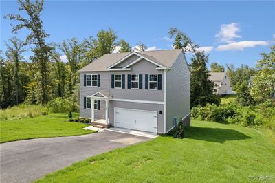 View of front of property with a front yard and a garage | Image 2