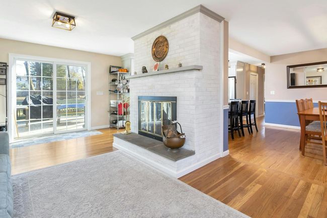 Family room has sliding glass door to spacious deck and rear yard. Handsome tile apron in front of door. | Image 7