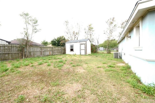 Fenced backyard with a shed | Image 17