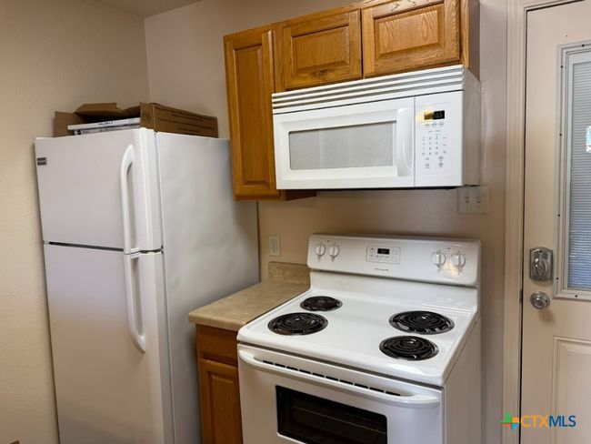 View of cozy kitchen with great appliances. | Image 21