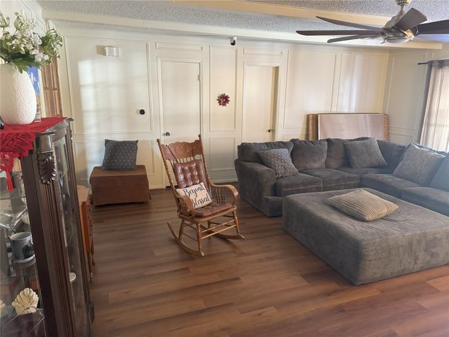 Living room featuring ceiling fan, dark hardwood / wood-style flooring, and a wealth of natural light | Image 9