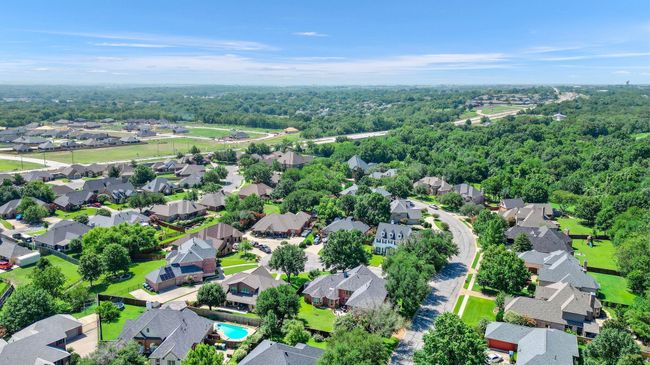 Aerial view of residential area featuring a heavily wooded area | Image 39