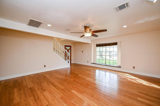 Enter the family room through a hallway or through a second front entry door. | Image 14