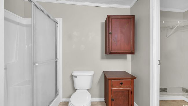 Bathroom with a stall shower, a spacious closet, and ornamental molding | Image 20