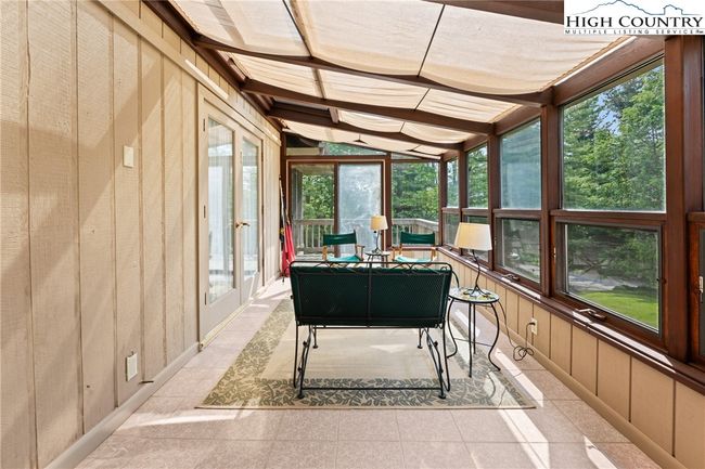 Sunroom is located on the front of the house accessible by the dining room and the front porch. | Image 34