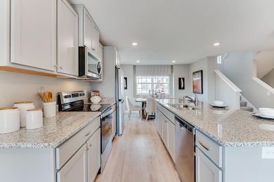 Plenty of counter space, plenty of storage, and a vented microwave fan make mealtime more enjoyable! Model home, details will vary. | Image 3