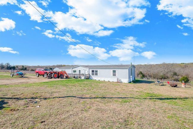 Rear view of property featuring a yard | Image 12