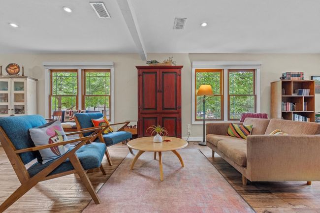 MAIN: Living area featuring recessed lighting, wood-look finished floors, and a wealth of natural light | Image 8
