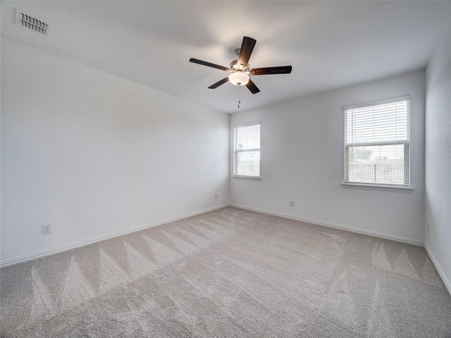 Spare room featuring carpet flooring, ceiling fan, and baseboards | Image 26