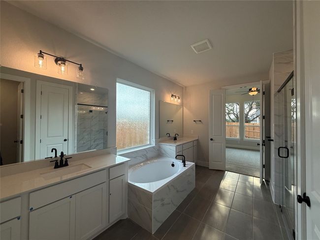 Primary Bath with dual vanities, garden tub & walk-in shower | Image 12