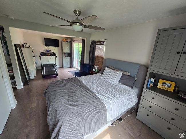 Bedroom featuring baseboards, a ceiling fan, wood finished floors, and access to outside | Image 25