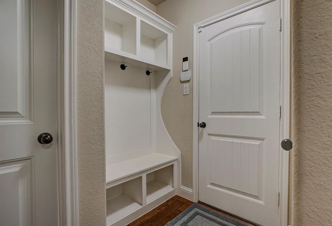 Mudroom with dark wood-style flooring and a textured wall | Image 20