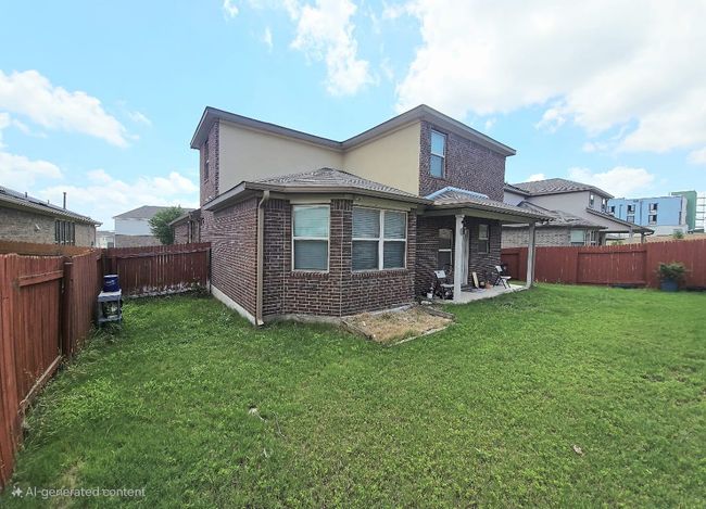 Back of house with brick siding, a fenced backyard, and a patio area | Image 25