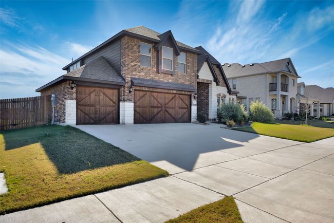 View of front of property featuring a garage and a front yard | Image 8
