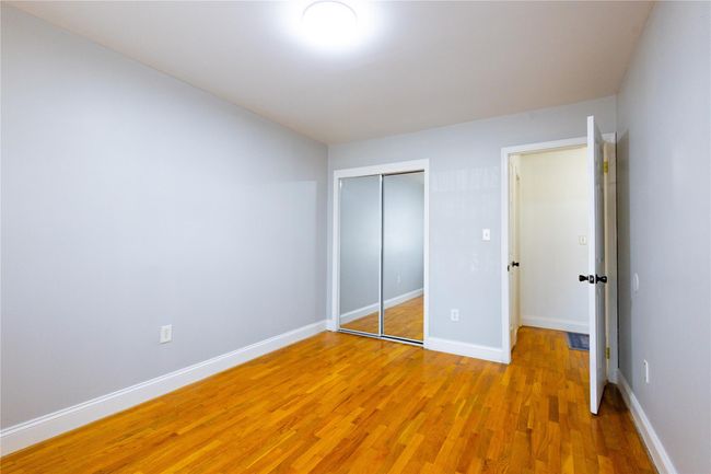 Unfurnished bedroom featuring light wood-style flooring, baseboards, and a closet | Image 18