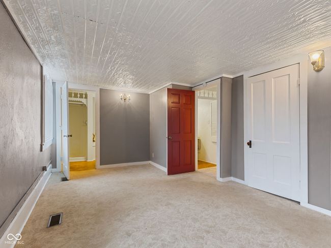 unfurnished bedroom with light carpet, baseboards, visible vents, and wooden ceiling | Image 18