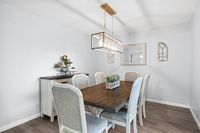 Formal Dining space with French country furniture, farmhouse sized table and chairs, nice chandelier | Image 5