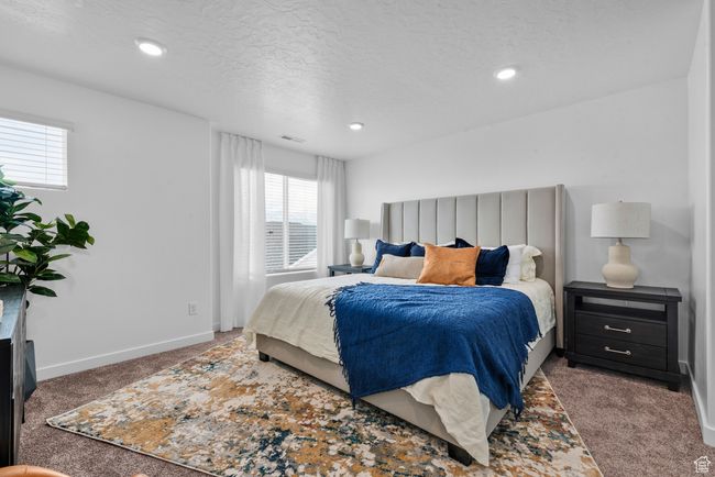 Bedroom featuring carpet flooring, a textured ceiling, and recessed lighting | Image 14
