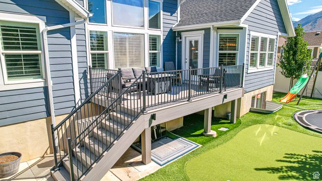 Deck featuring a mountain view and a playground | Image 46