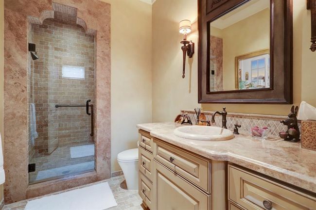 Third bedroom bathroom has walk in shower, limestone counters and onyx sink. | Image 34