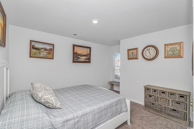 Bedroom featuring light colored carpet | Image 16