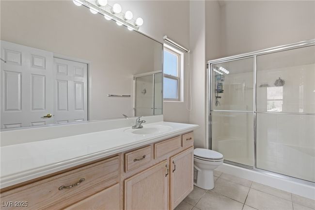 Full bathroom with a shower stall, vanity, and tile patterned flooring | Image 25