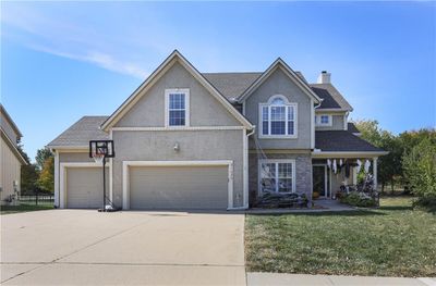 View of front of house with a front lawn and a garage | Image 1