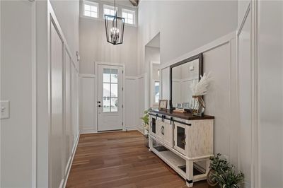 Foyer featuring a high ceiling, a chandelier, and hardwood floors | Image 3