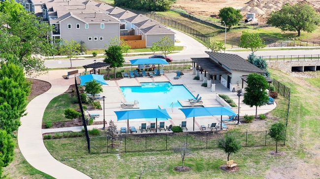 Community pool with fence and a patio area | Image 6