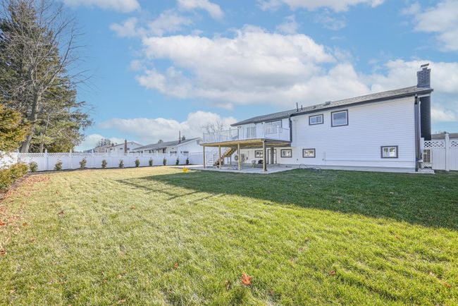 View of yard featuring a patio area and a deck | Image 8