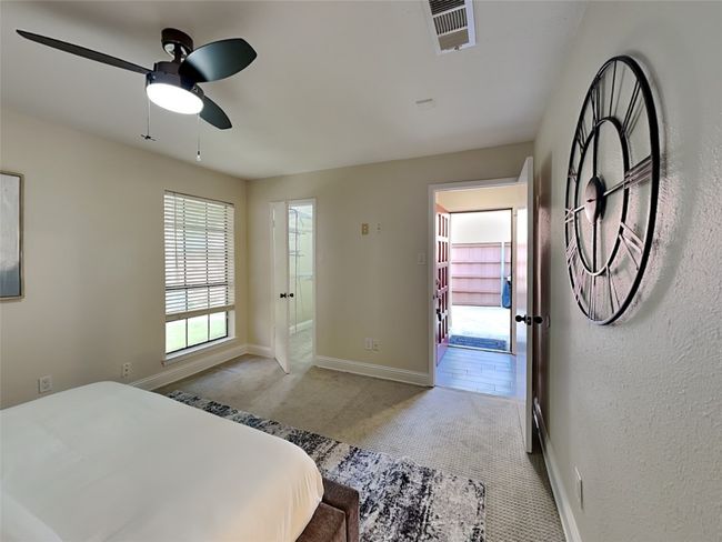 Carpeted bedroom featuring baseboards, a ceiling fan, and visible vents | Image 4