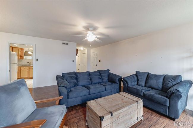 Living area featuring hardwood / wood-style flooring and a ceiling fan | Image 10