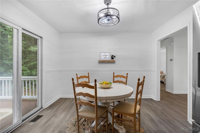 Dining area with wood finished floors and baseboards | Image 4