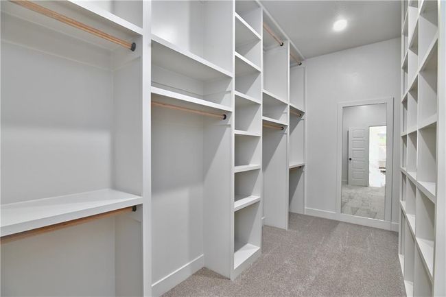 Walk in closet with light carpet | Image 29