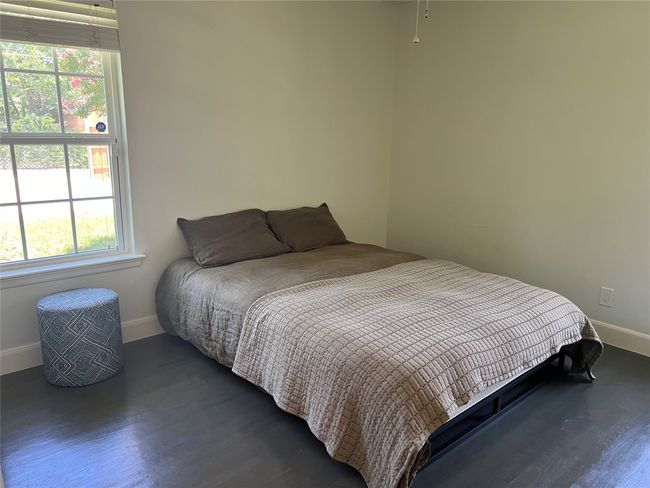 View of the guest bedroom 2 with laminate wood floors, view of backyard | Image 16