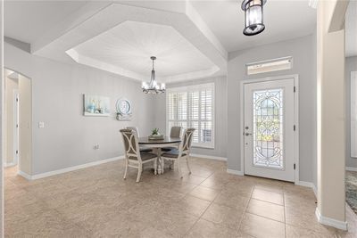 Formal Dining Room with elegant tray ceilings. | Image 3