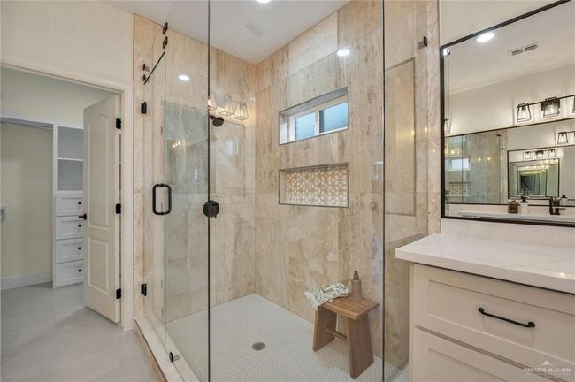 Bathroom featuring a stall shower, vanity, and tile patterned flooring | Image 15