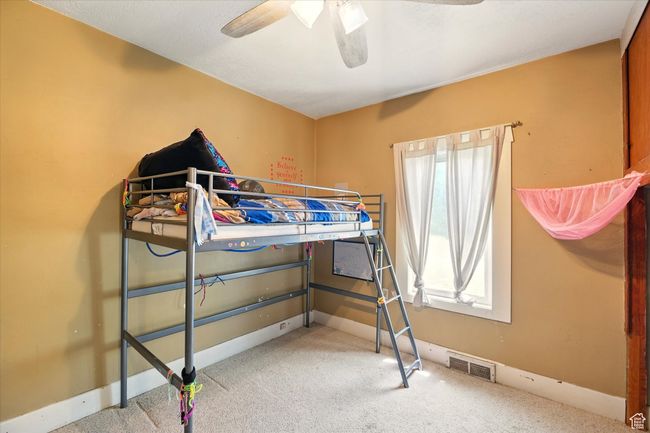 Bedroom featuring carpet floors, a ceiling fan, and baseboards | Image 13