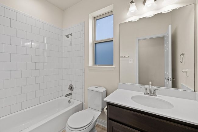 Bathroom featuring vanity and bathtub / shower combination | Image 34