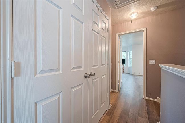 Doors to the washer/dryer and a sneak peak into the primary retreat. | Image 17