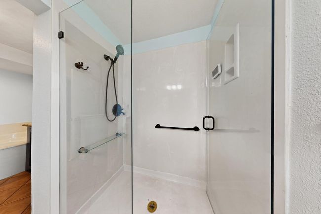 Bathroom with a shower stall and tile patterned flooring | Image 16