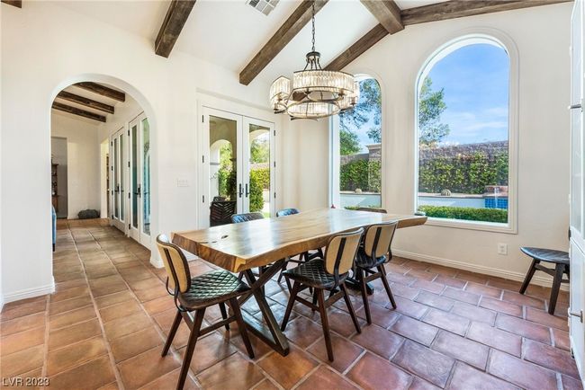 Vaulted ceilings with new wood beams and new light fixture, lots of natural light and access to backayrd patio. | Image 10